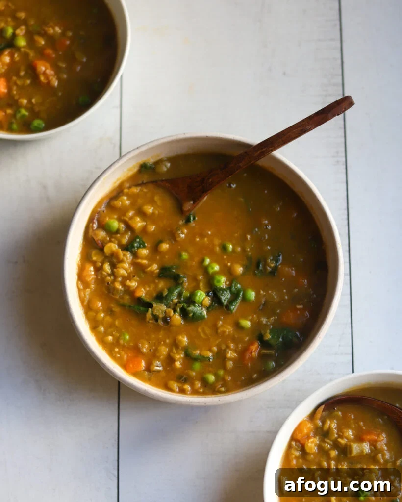 overhead view of 3 bowls of vegan split pea soup with veggies