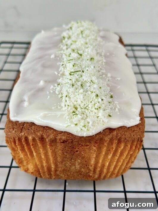 a full coconut loaf cake with a white icing 