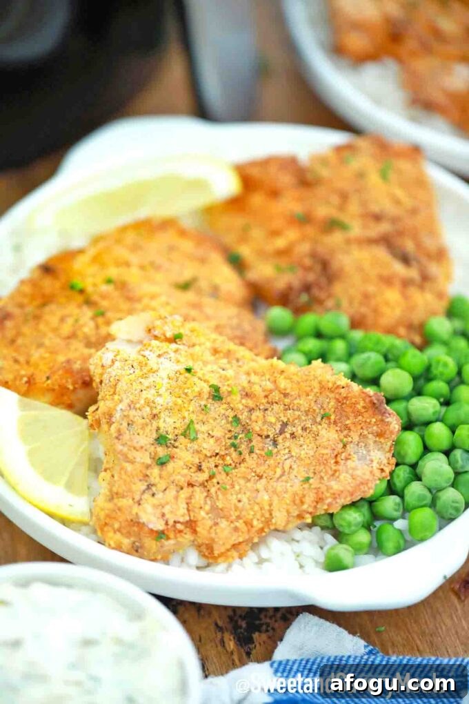 Air fried crispy fish served with rice and green peas.