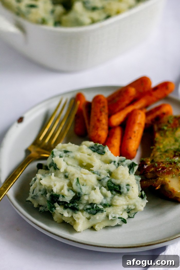 Image shows a dinner plate with roasted carrots, mashed potatoes and a fork