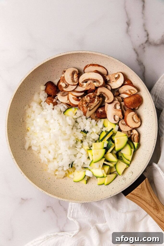 mushrooms, onions, and zucchini in saute pan