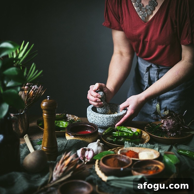woman pounds garlic in molcajete for mole sauce and mexican rice