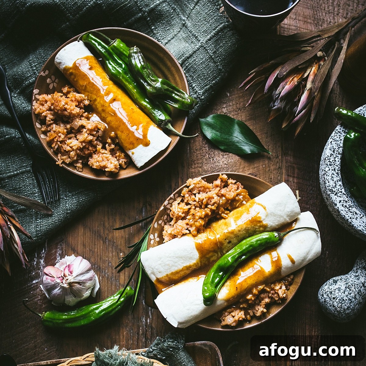 enchiladas topped with quick and easy mole sauce and surrounded by spanish rice and bright green chilis.