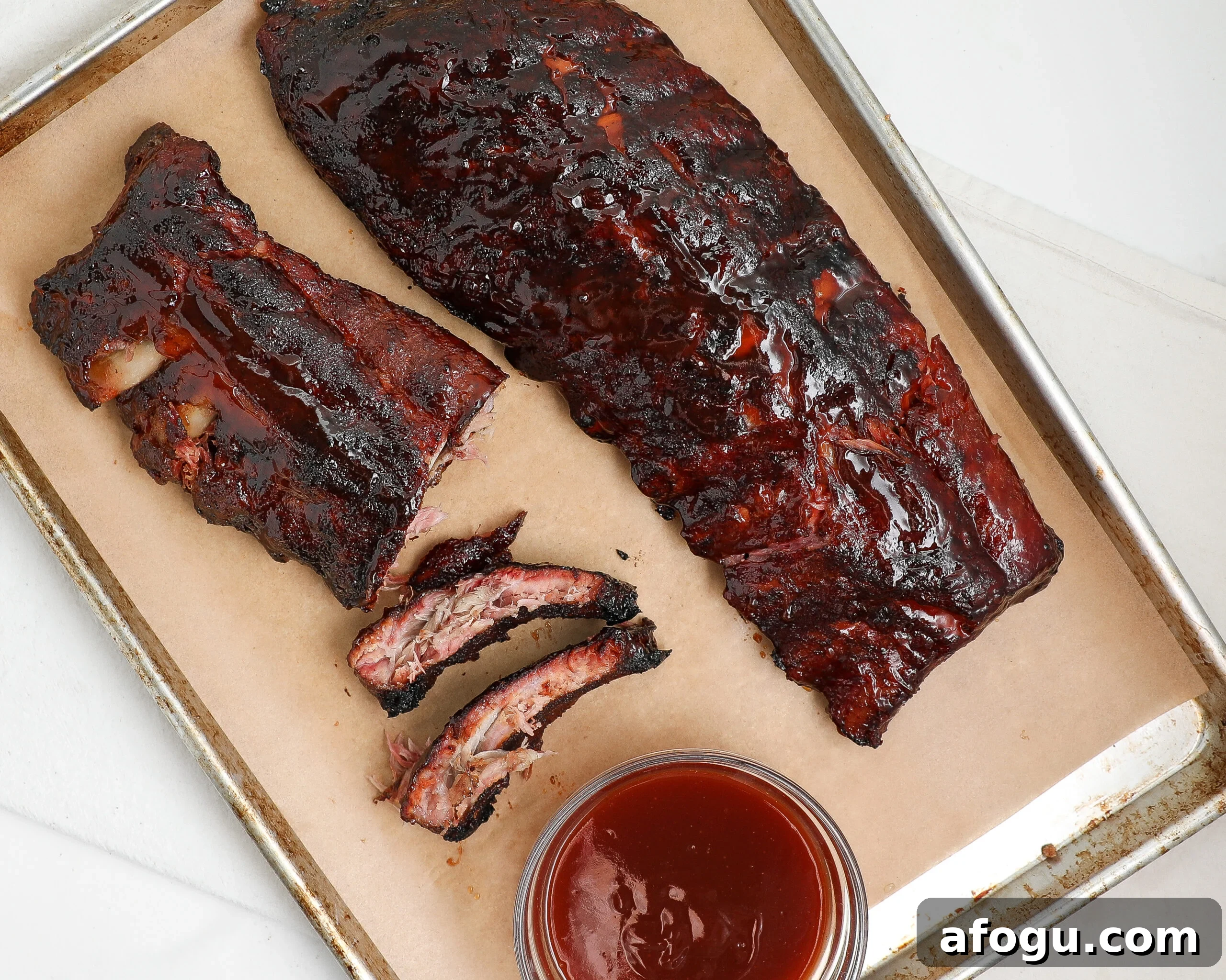 Smoked BBQ ribs glazed with barbecue sauce and sliced between the bones.