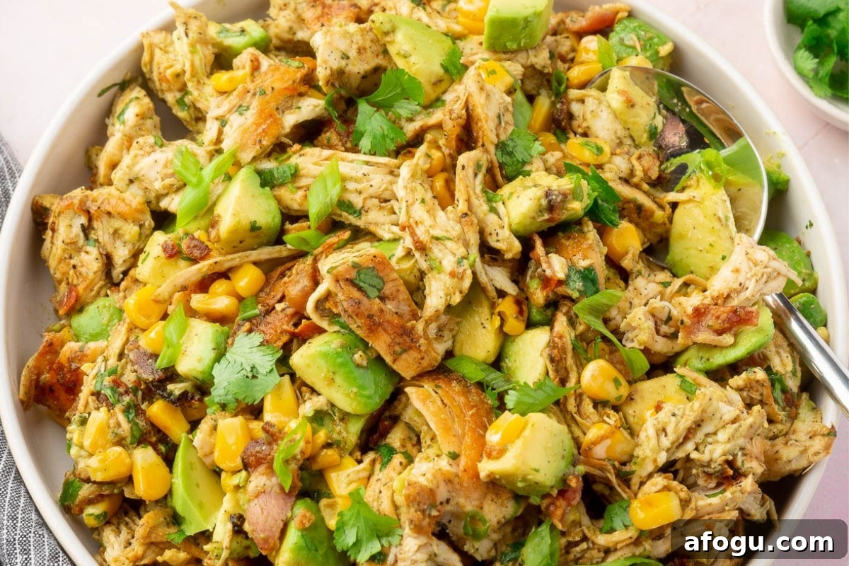 A large bowl of avocado chicken salad on a countertop.