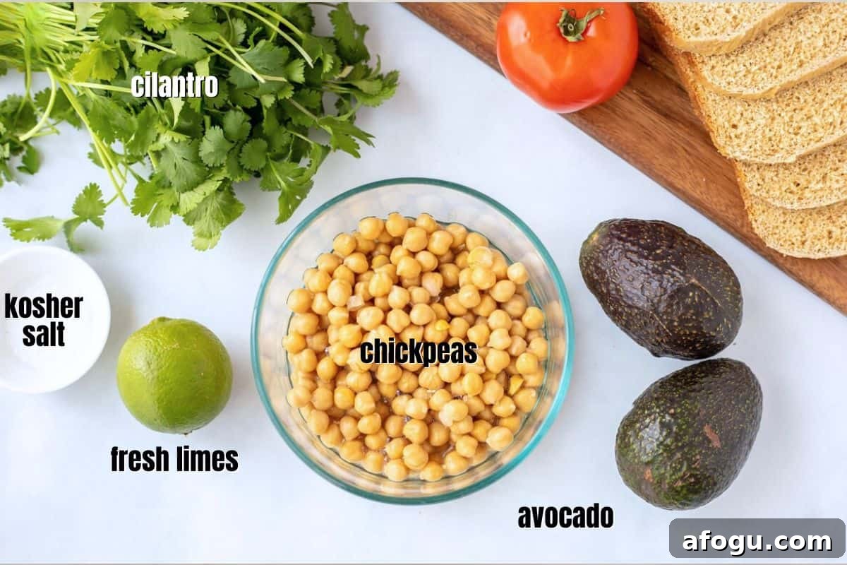 Ingredients for chickpea salad with avocado on counter.