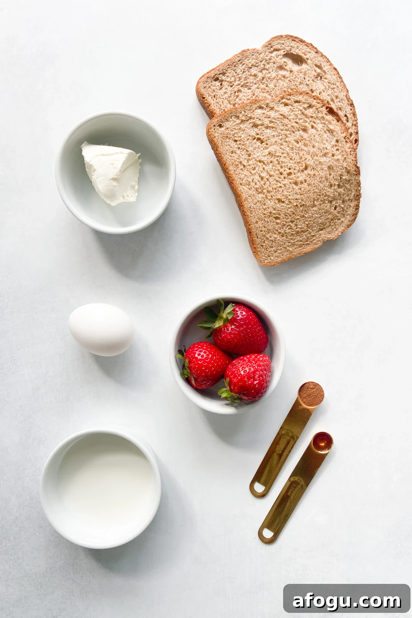 Ingredients to make strawberry cheesecake rollups. See recipe card for detailed ingredient quantities.