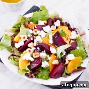 Plate of roasted beet and orange salad served with citrus vinaigrette.