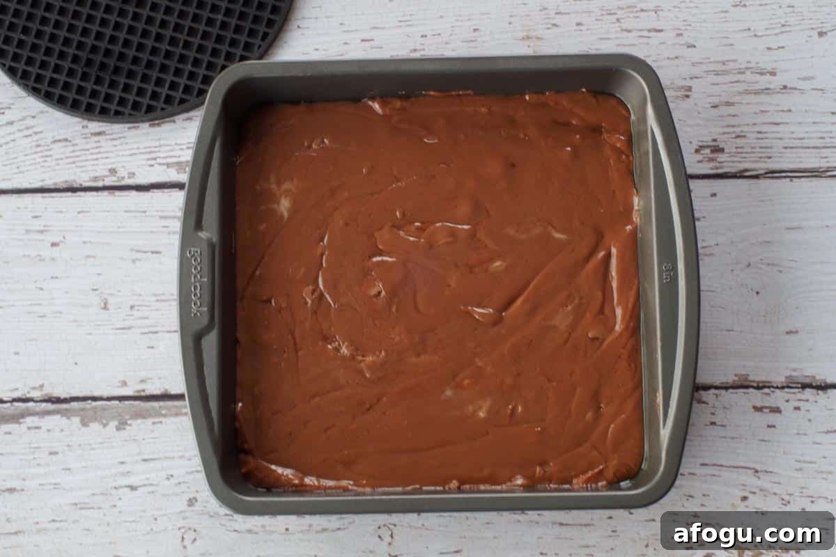 Fudge mixture transferred to a square prepared pan.