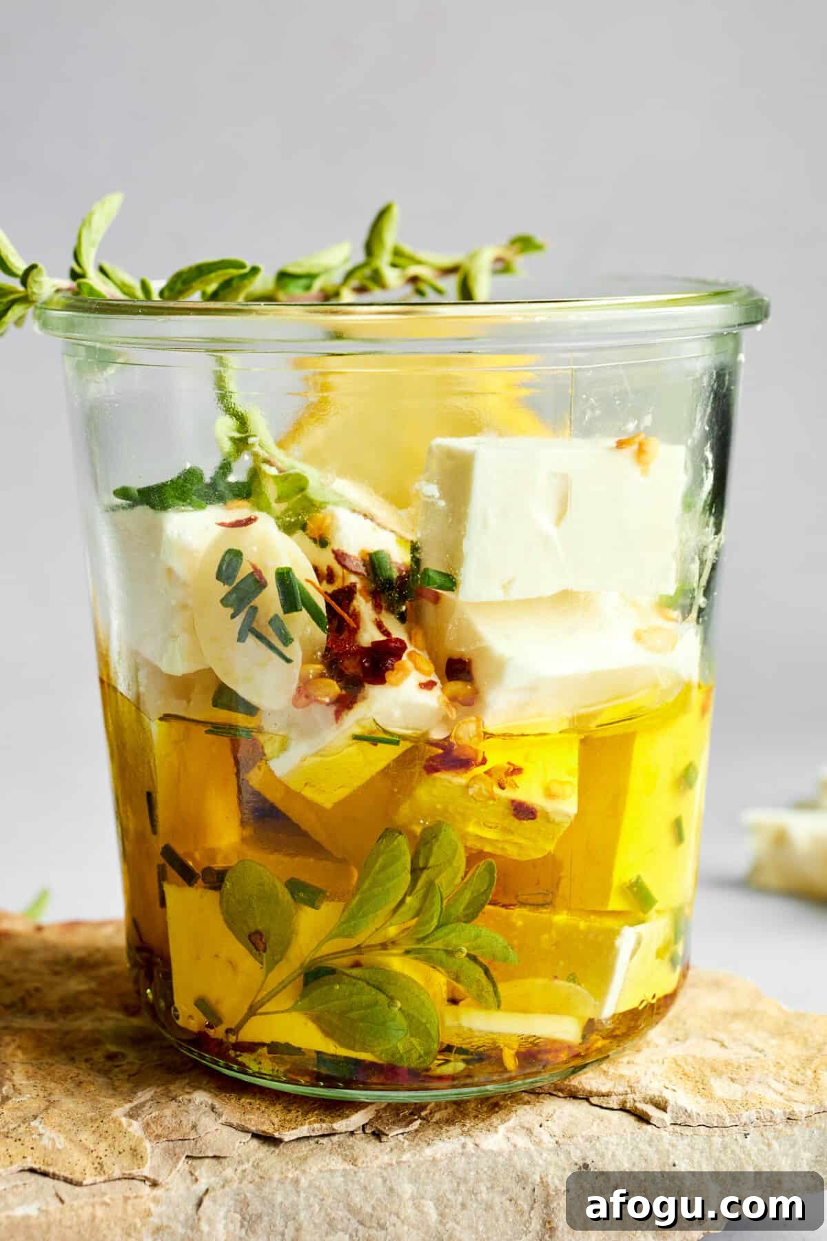 Feta cubes marinading in olive oil.