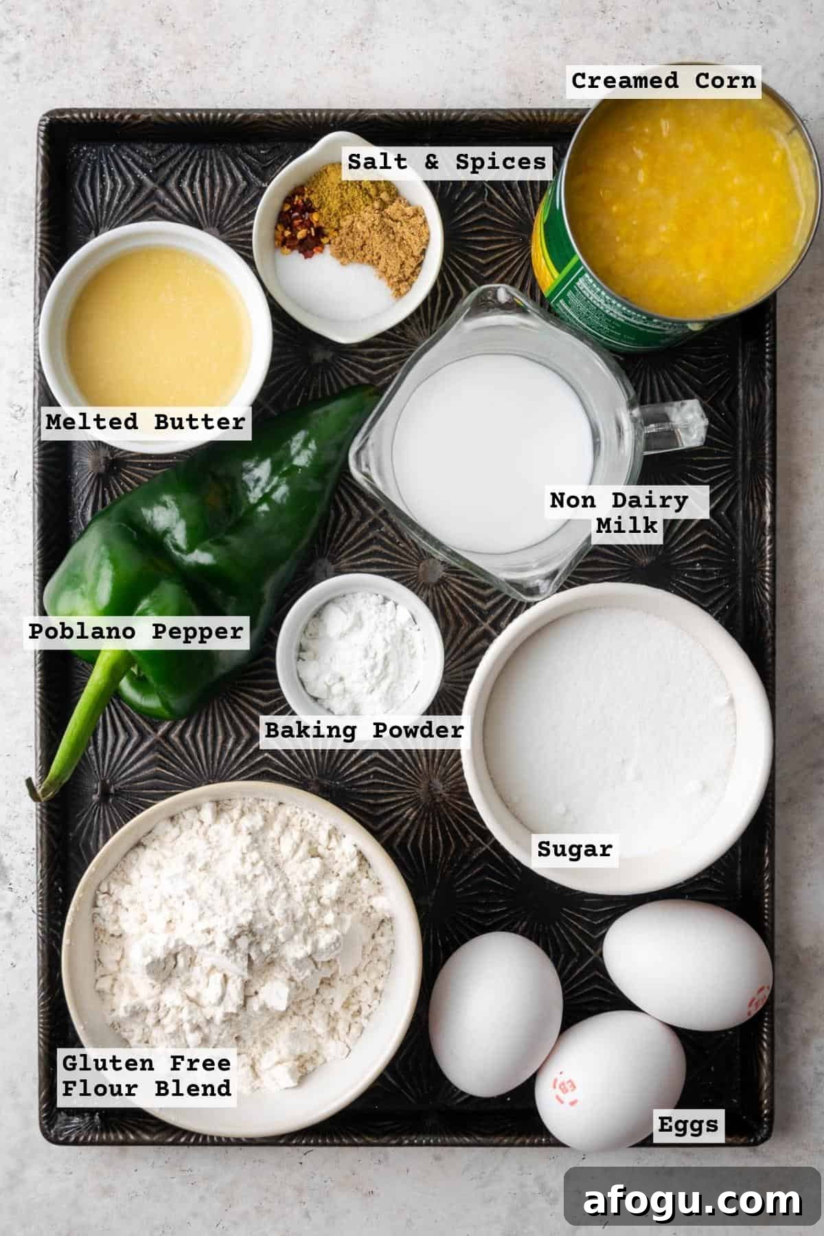 Ingredients for gluten free corn casserole sitting on a metal baking sheet.