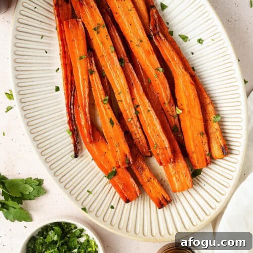 Maple glazed carrots served on a large ceramic platter.