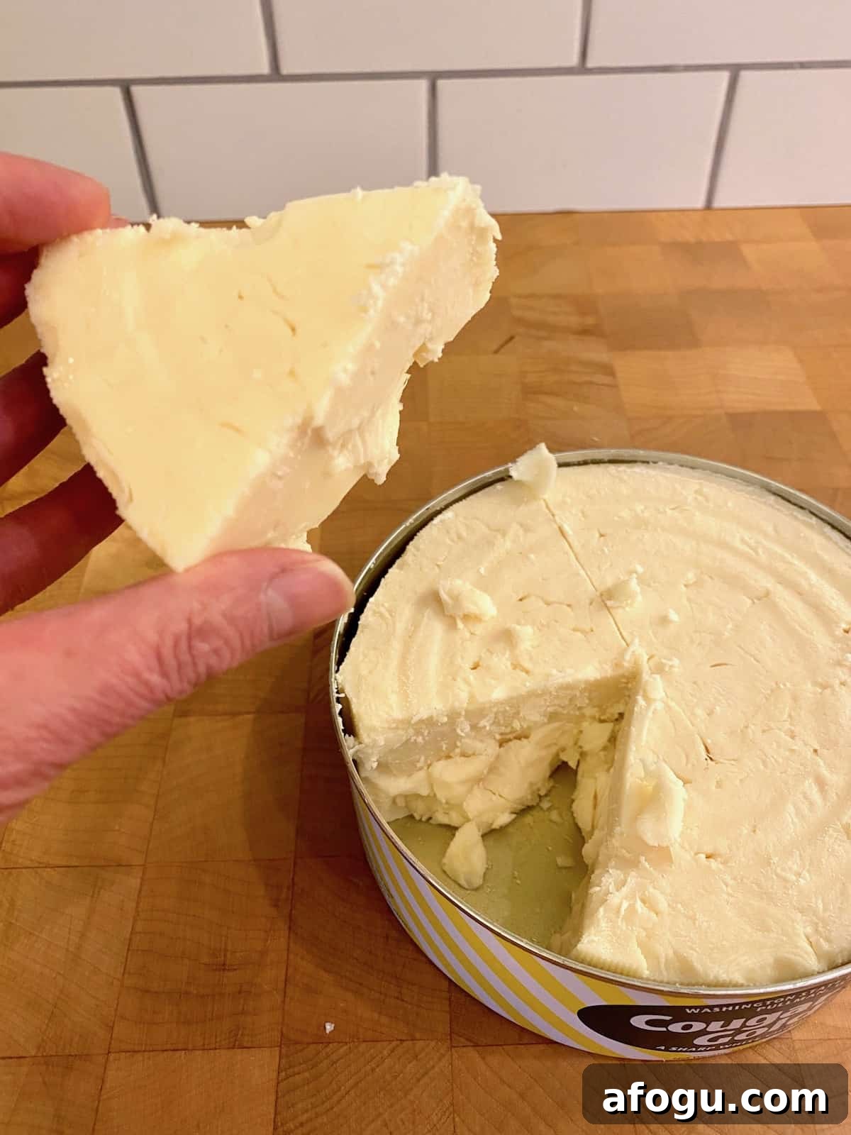 A wedge of white sharp cheddar cheese.
